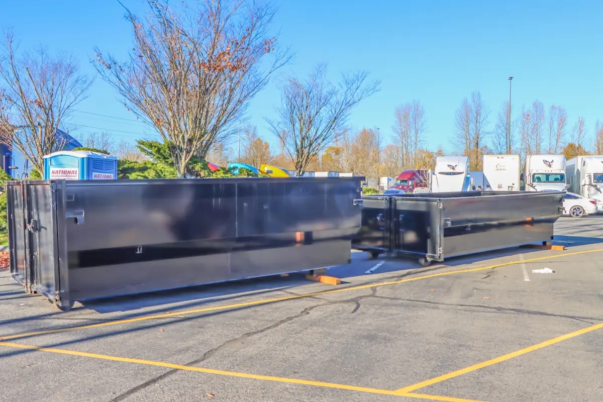 Professional dumpster rental service with roll-off container on residential driveway in Albuquerque